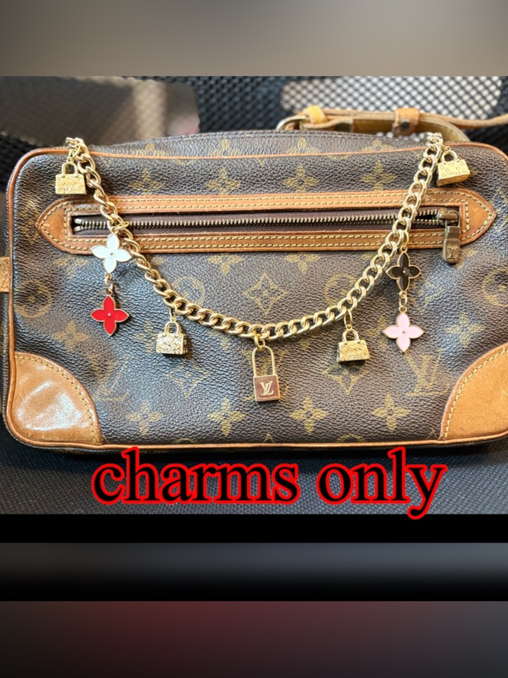 Authentic Louis Vuitton Lock Charm and other unbranded charms on bag chain